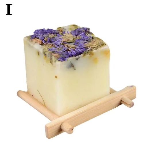 Savon Artisanal aux Huiles Essentielles de Plantes with purple flower accents on a wooden tray.